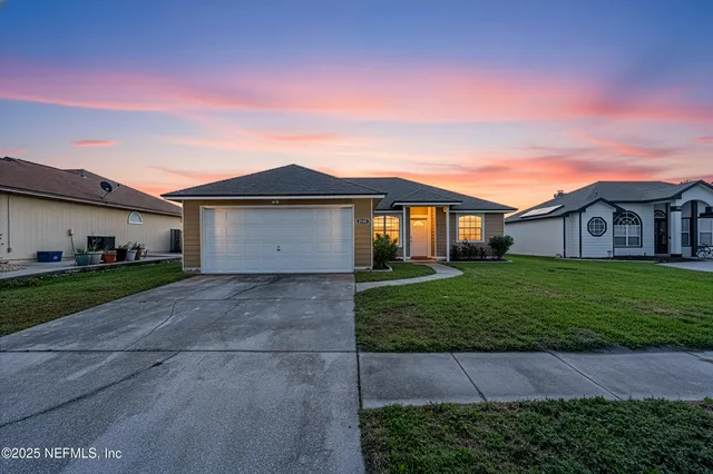 a front view of a house with a garden