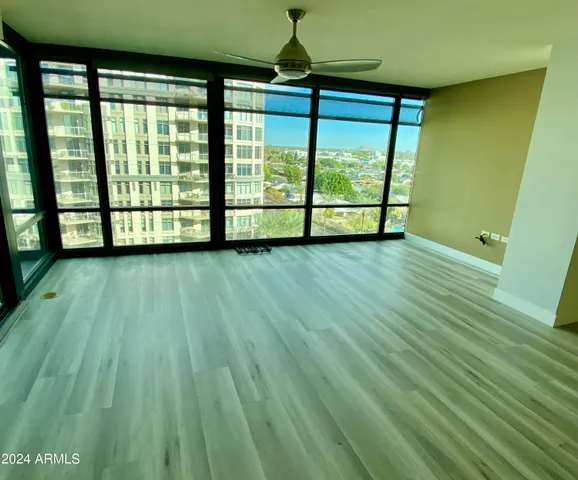 a view of a room with wooden floor and windows