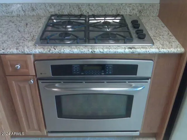 a stove top oven sitting inside of a kitchen
