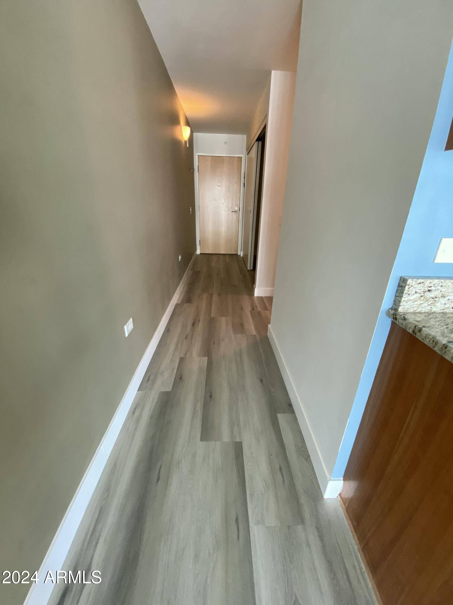4808 North 24th Street, Unit 902 Phoenix, AZ 85016 - Photo 10 of 17 a view of a hallway with wooden floor