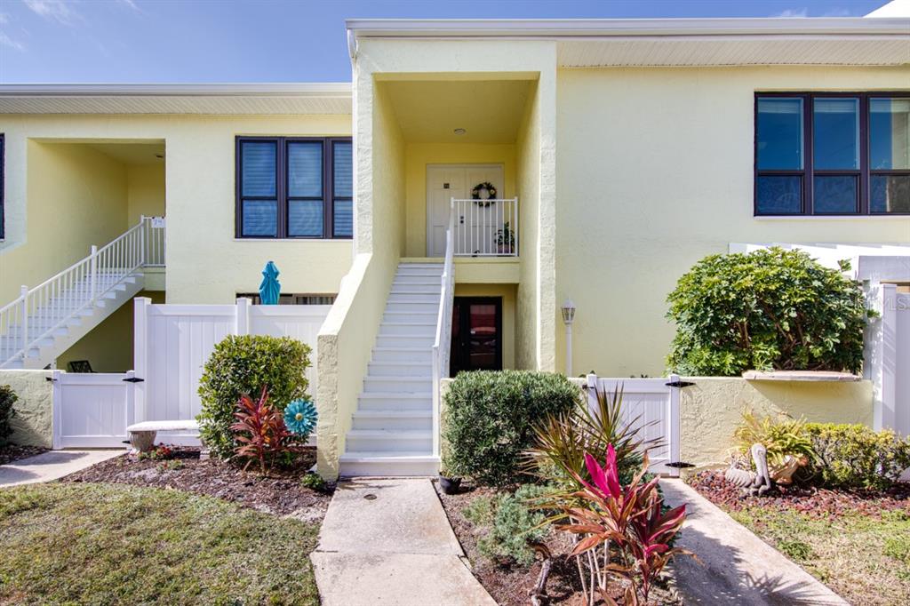 1 Windrush Boulevard, Unit 76 Indian Rocks Beach, FL 33785 - Photo 1 of 1 a front view of a house with a yard