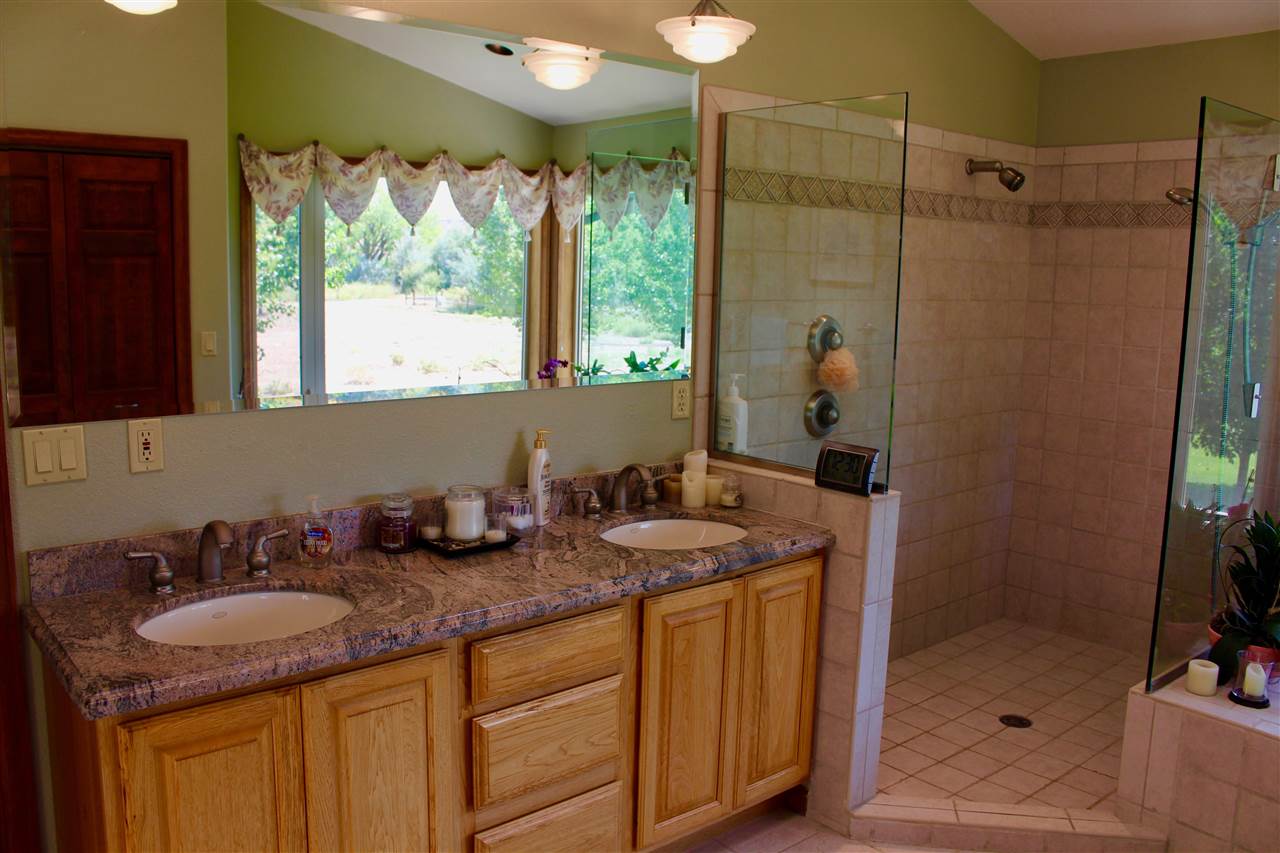 53716 Falcon Road Olathe, CO 81425 - Photo 4 of 39 a bathroom with a granite countertop sink and a mirror