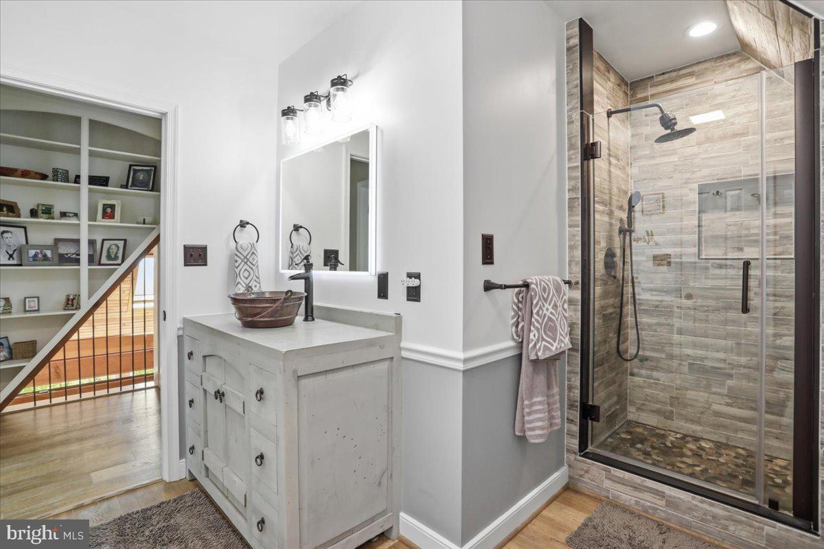 19897 Foresthill Road Bluemont, VA 20135 - Photo 23 of 39 a bathroom with a sink a mirror and shower