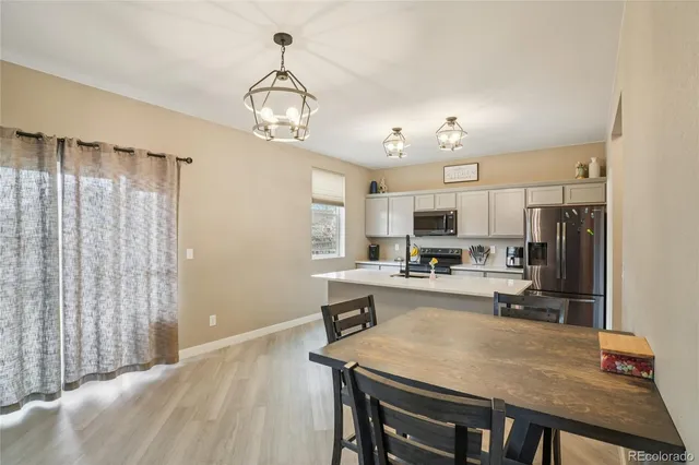 a kitchen with sink cabinets and refrigerator