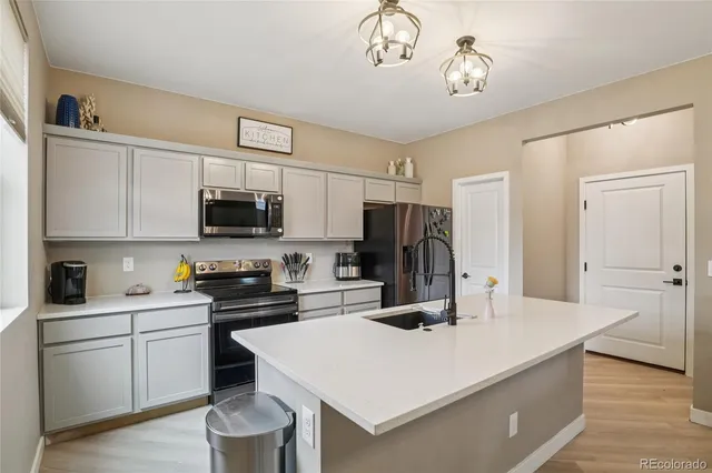 a kitchen with a sink a stove and refrigerator