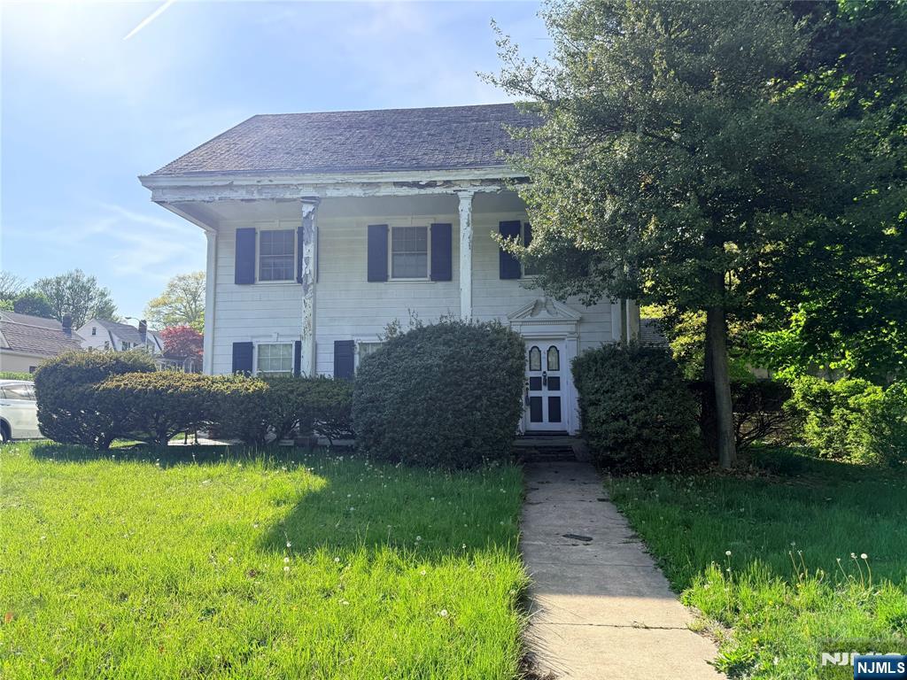 599 South Center Street Orange, NJ 07050 - Photo 1 of 19 a brick house with a yard plants and large tree
