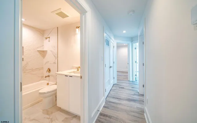 a view of a bathroom from a hallway