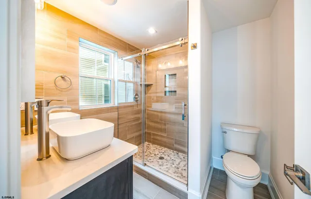 a bathroom with a sink toilet and shower