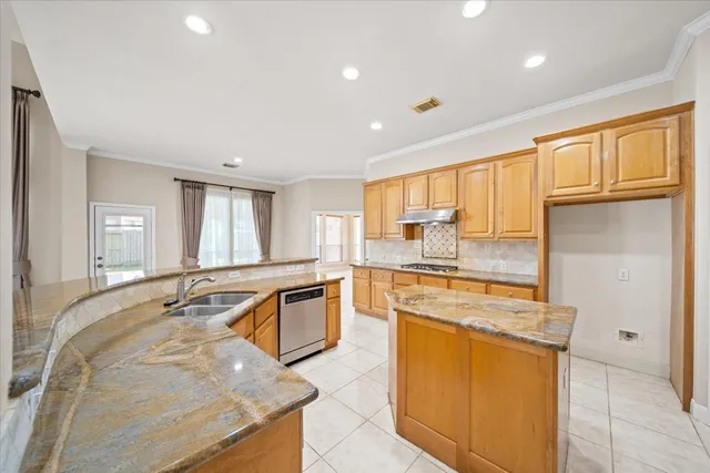 a kitchen with stainless steel appliances granite countertop a sink stove and refrigerator