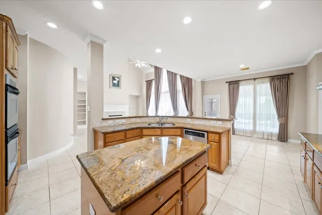 a bathroom with a tub a sink and a large window