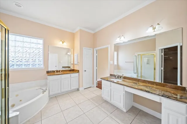 a large bathroom with a tub a sink double vanity and a shower