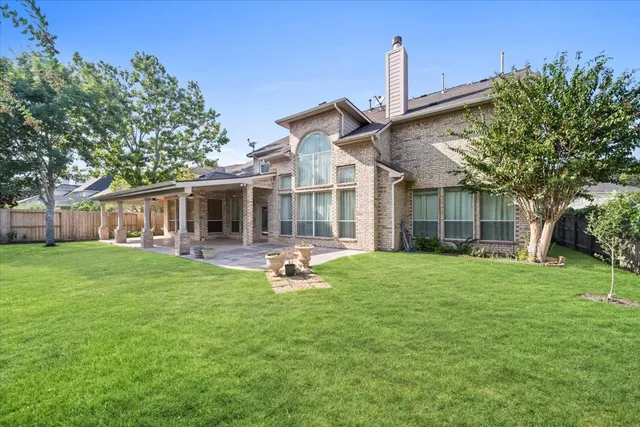 a front view of house with a garden and patio
