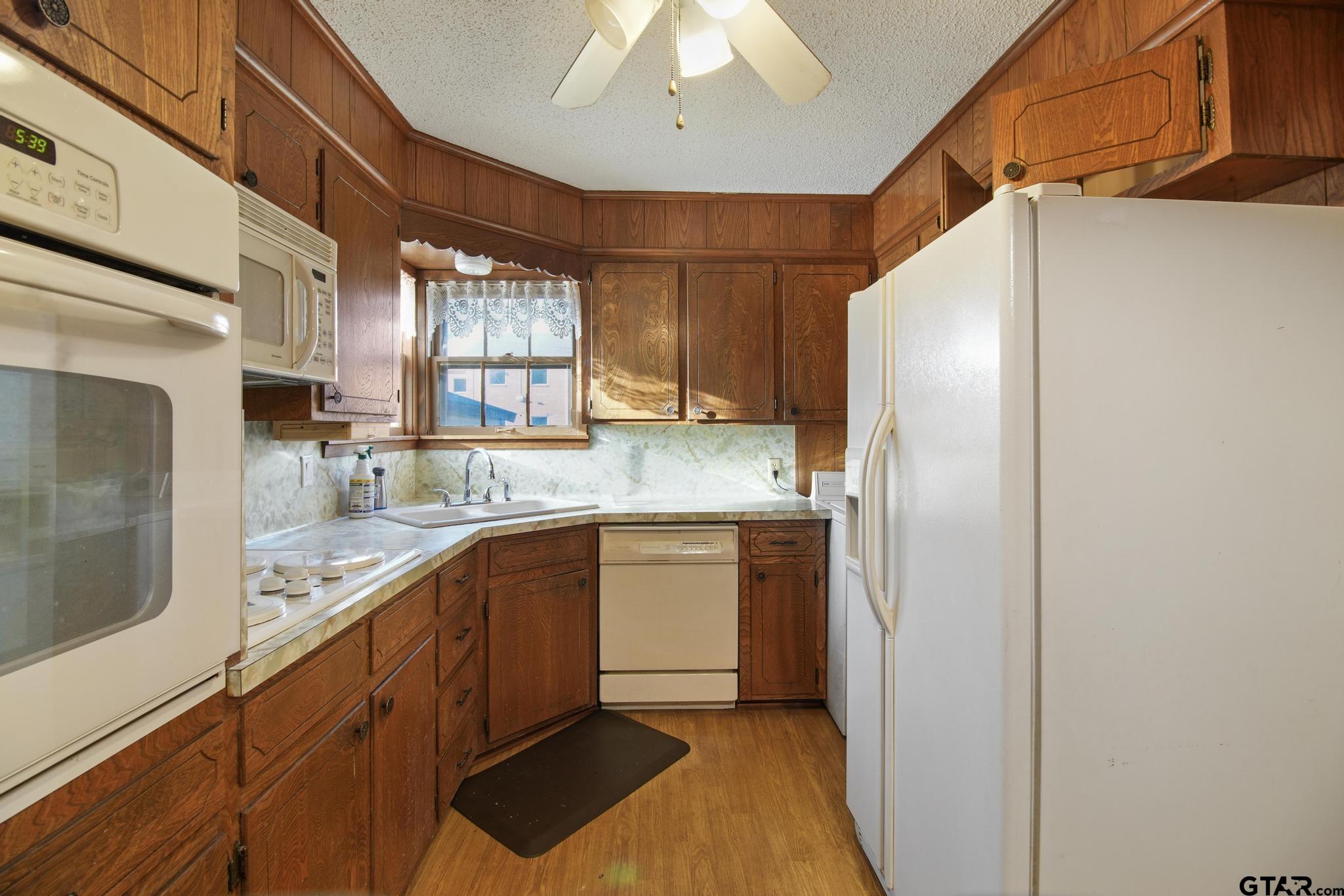 1919 East Ferdell Street Tyler, TX 75701 - Photo 13 of 24 a kitchen with stainless steel appliances granite countertop a refrigerator and a sink