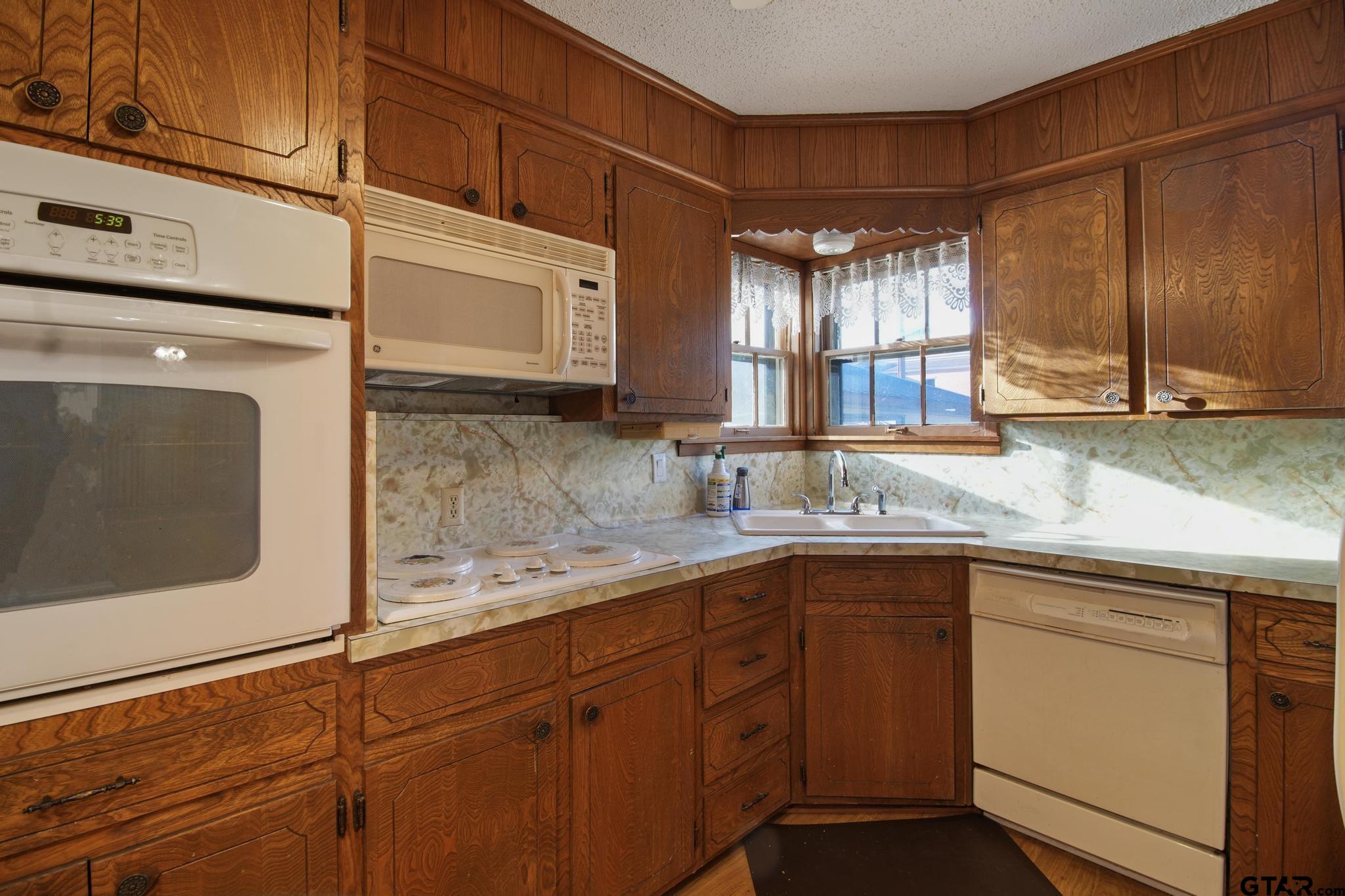 1919 East Ferdell Street Tyler, TX 75701 - Photo 14 of 24 a kitchen with a sink and cabinets