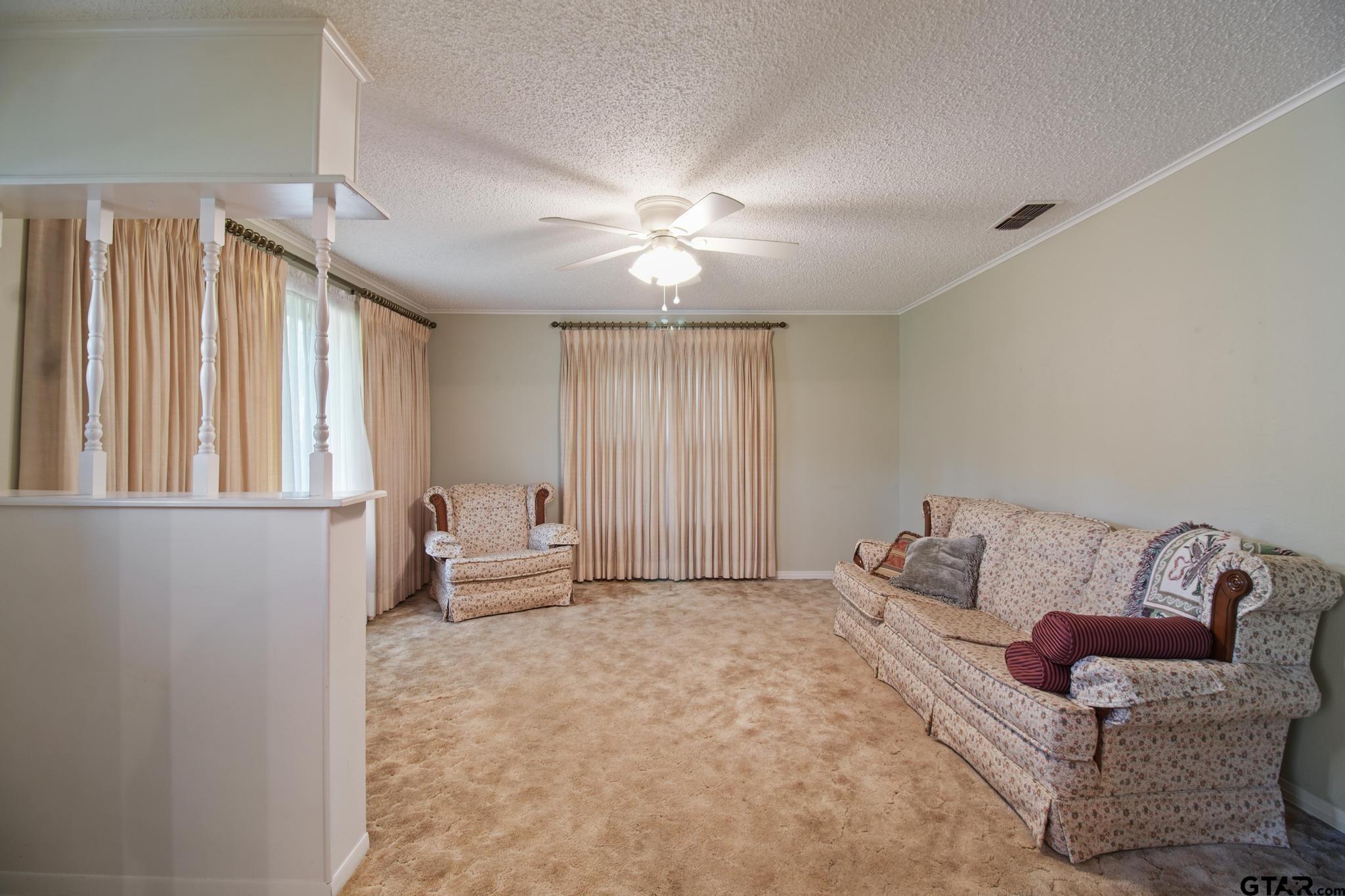 1919 East Ferdell Street Tyler, TX 75701 - Photo 15 of 24 a living room with furniture and a chandelier
