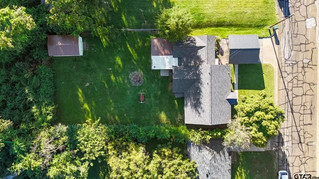 a backyard of a house with table and chairs