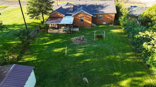 a front view of a house with a yard table and chairs