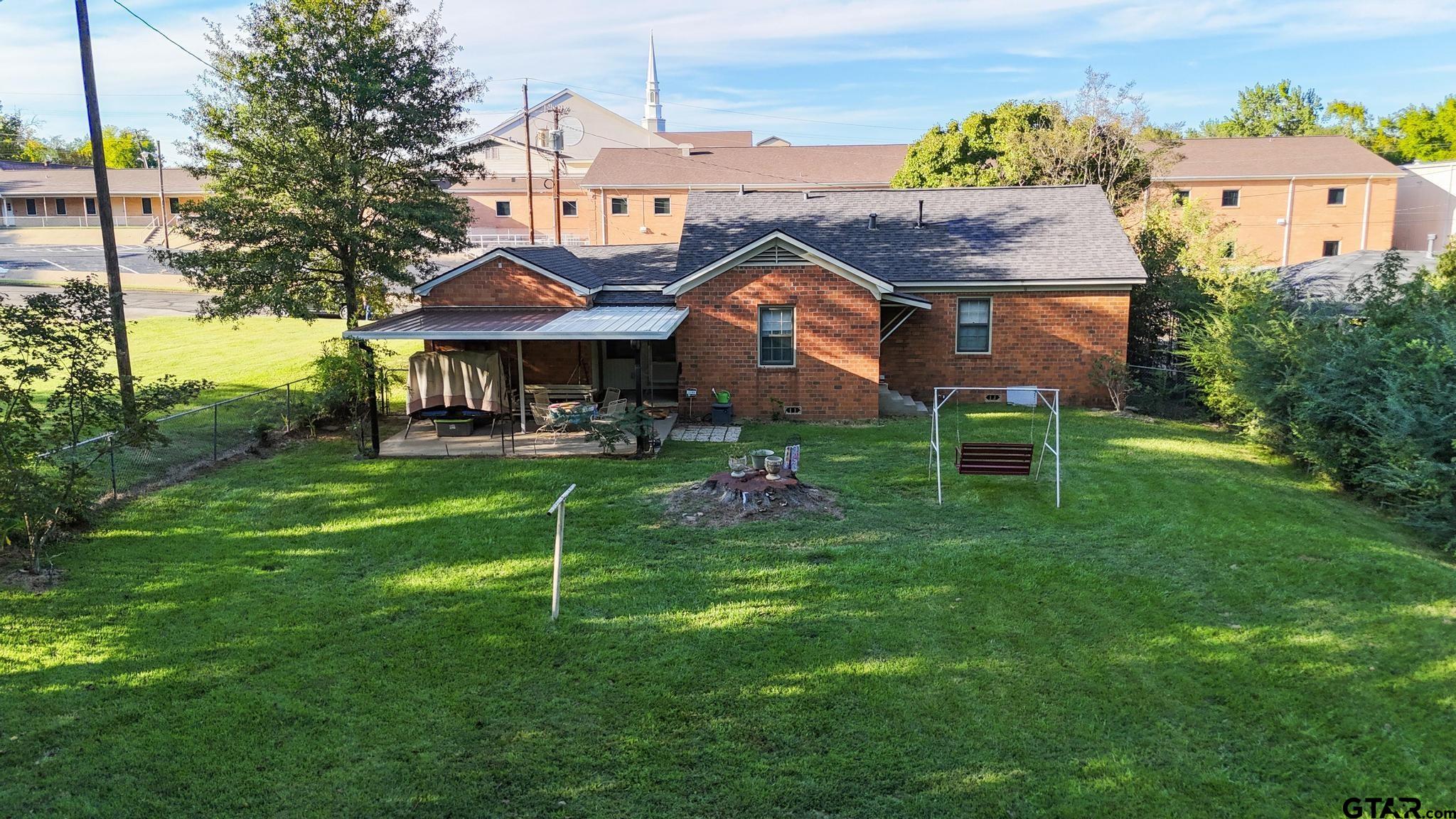 1919 East Ferdell Street Tyler, TX 75701 - Photo 24 of 24 a front view of a house with a yard table and chairs