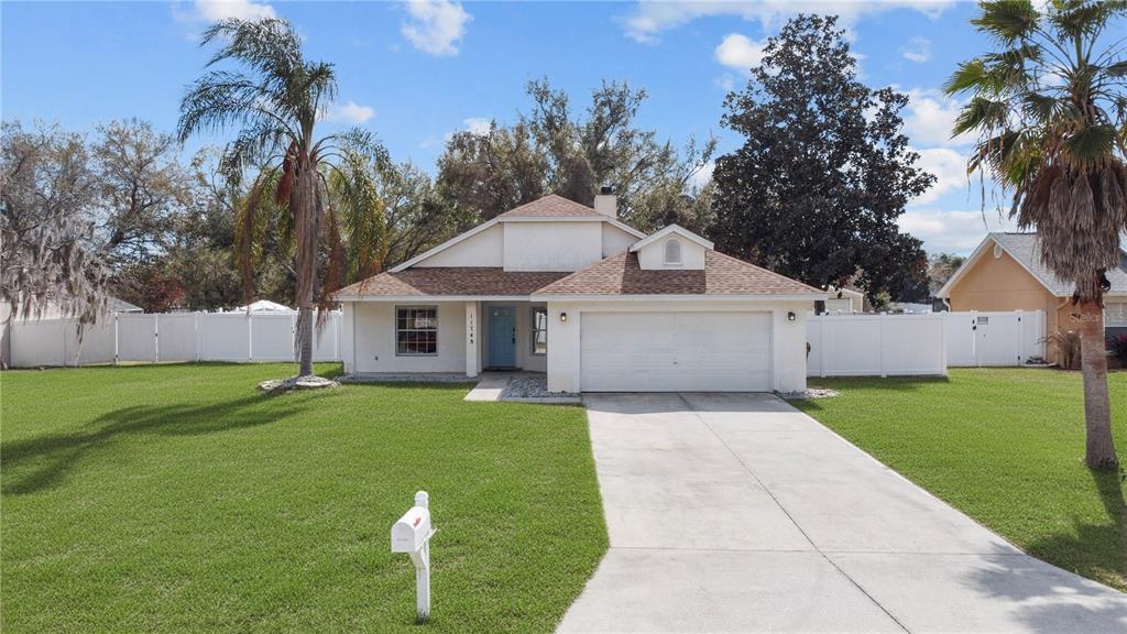 11748 Constance Way Clermont, FL 34711 - Photo 1 of 45 a front view of a house with garden