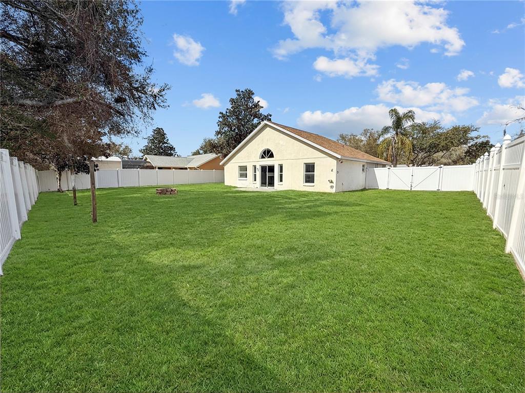11748 Constance Way Clermont, FL 34711 - Photo 13 of 45 a big house with a big yard and large trees