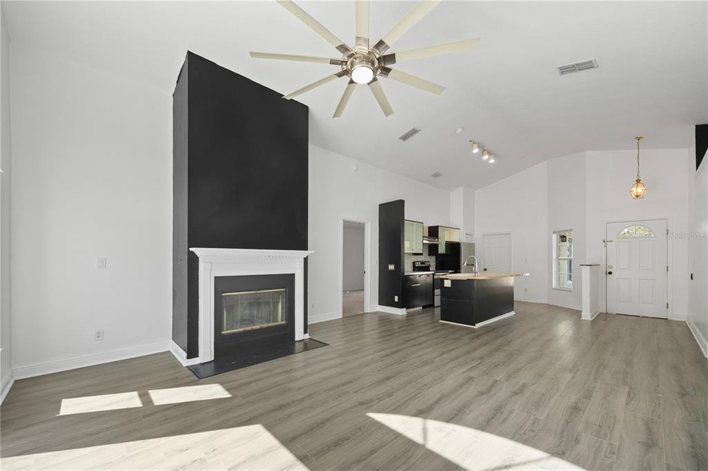 11748 Constance Way Clermont, FL 34711 - Photo 15 of 45 a living room with furniture fireplace and flat screen tv