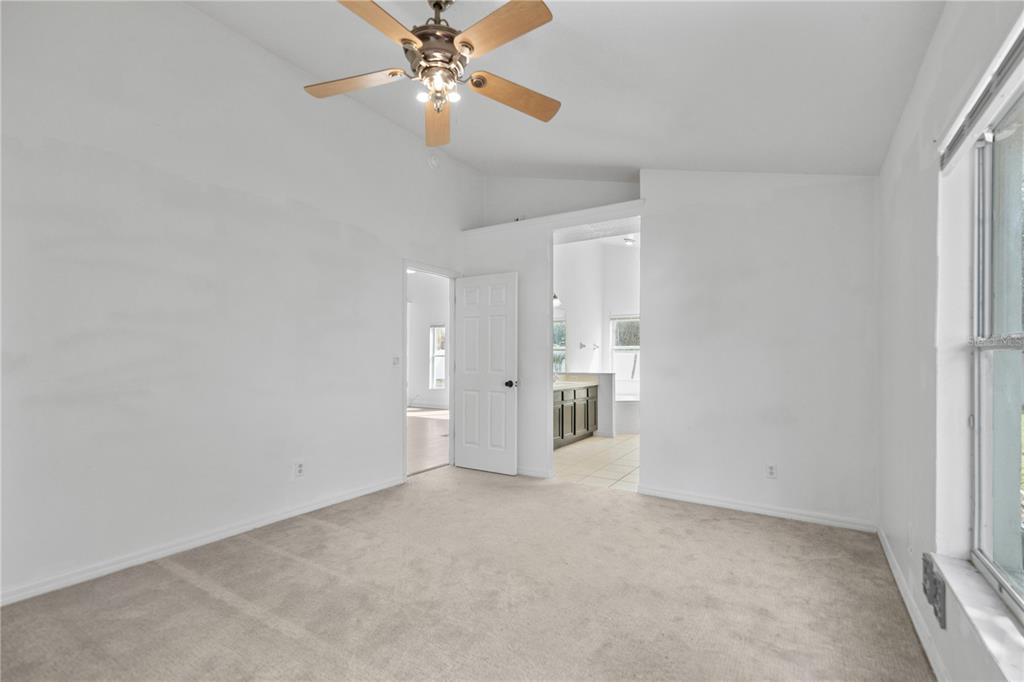 11748 Constance Way Clermont, FL 34711 - Photo 16 of 45 wooden floor in an empty room with a window