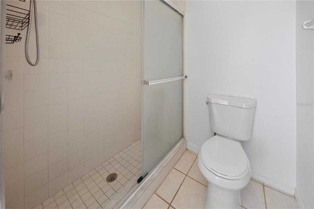 11748 Constance Way Clermont, FL 34711 - Photo 19 of 45 a bathroom with a toilet and a shower