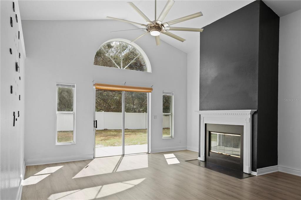 11748 Constance Way Clermont, FL 34711 - Photo 10 of 45 an empty room with fireplace and windows