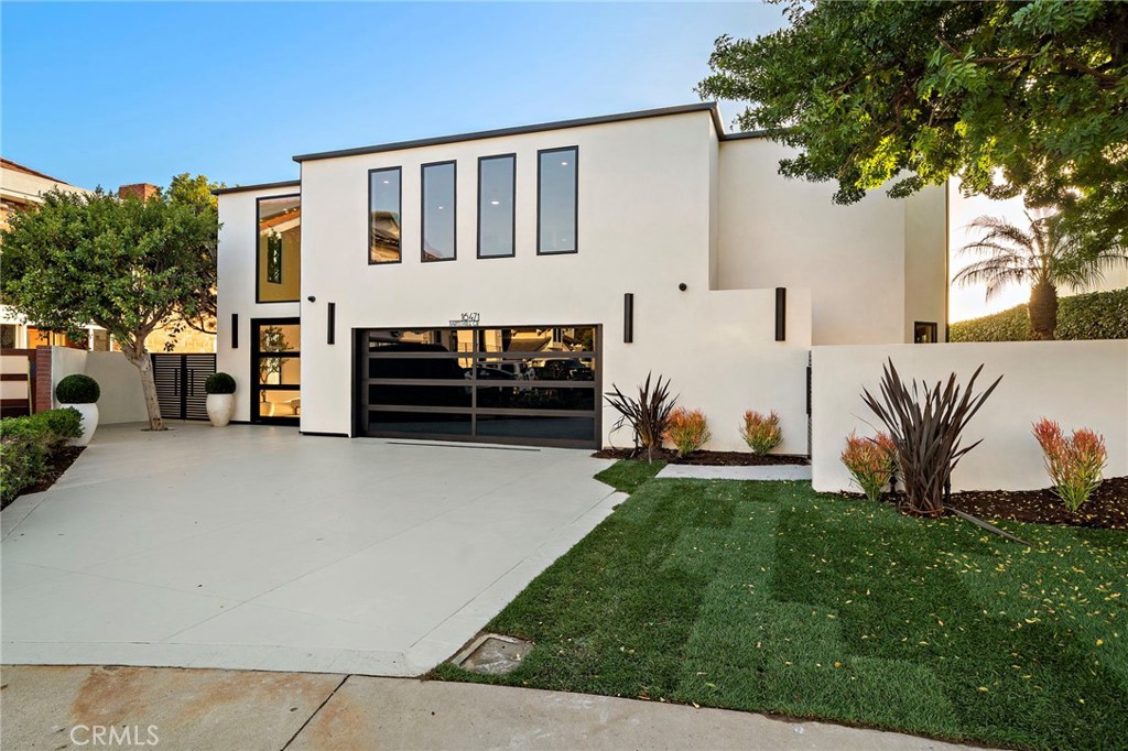 16471 Barnstable Circle Huntington Beach, CA 92649 - Photo 1 of 57 a front view of a house with a garden