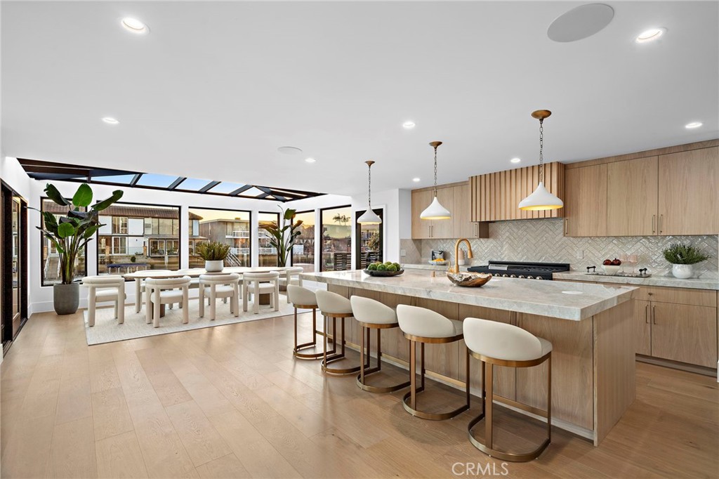 16471 Barnstable Circle Huntington Beach, CA 92649 - Photo 18 of 57 a large white kitchen with a large window