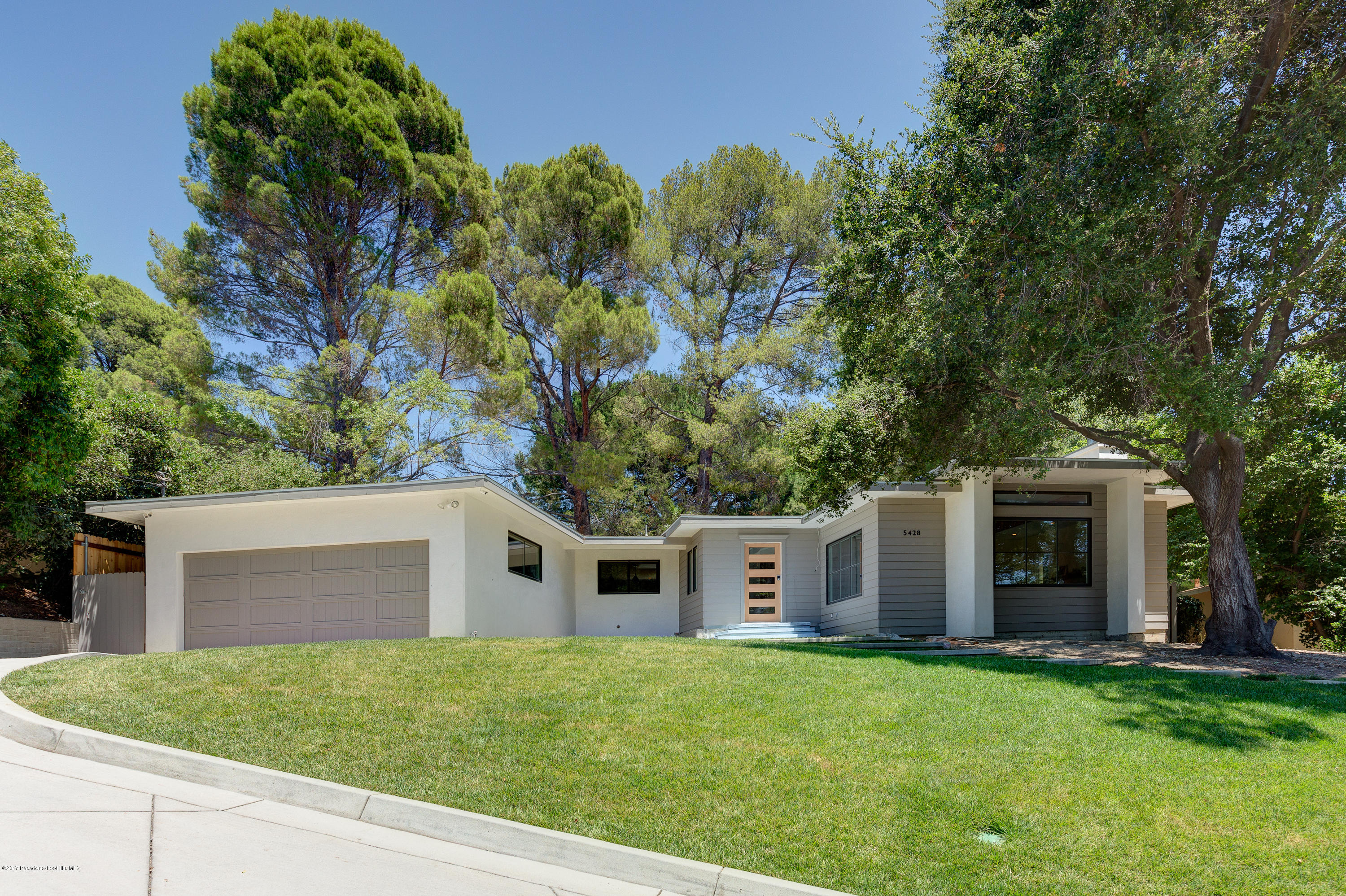 5428 La Forest Drive La Canada Flintridge, CA 91011 - Photo 1 of 24 a front view of a house with a garden and yard