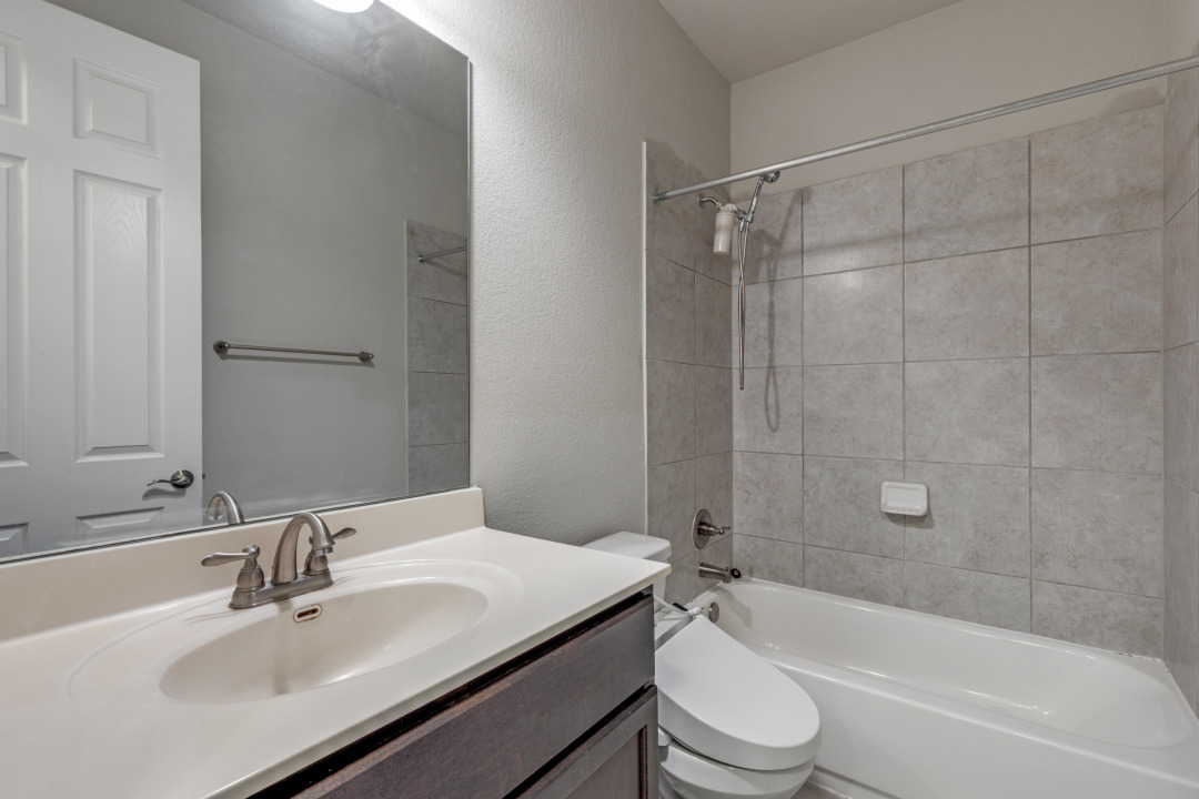 14904 Cabrillo Way Austin, TX 78738 - Photo 17 of 20 a bathroom with a sink a toilet and shower