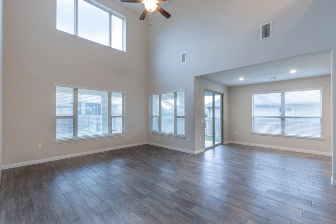 14904 Cabrillo Way Austin, TX 78738 - Photo 3 of 20 a view of an empty room with wooden floor and a window