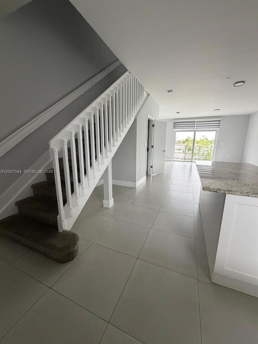 381 East 50th Street, Unit 6 Hialeah, FL 33013 - Photo 16 of 37 a view of staircase with white walls and a window