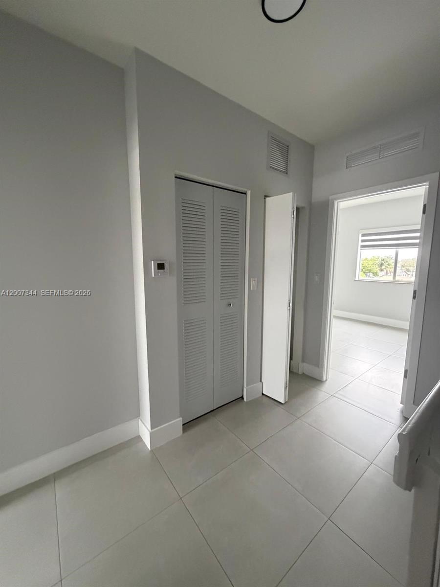 381 East 50th Street, Unit 6 Hialeah, FL 33013 - Photo 20 of 37 a view of an empty room with glass door