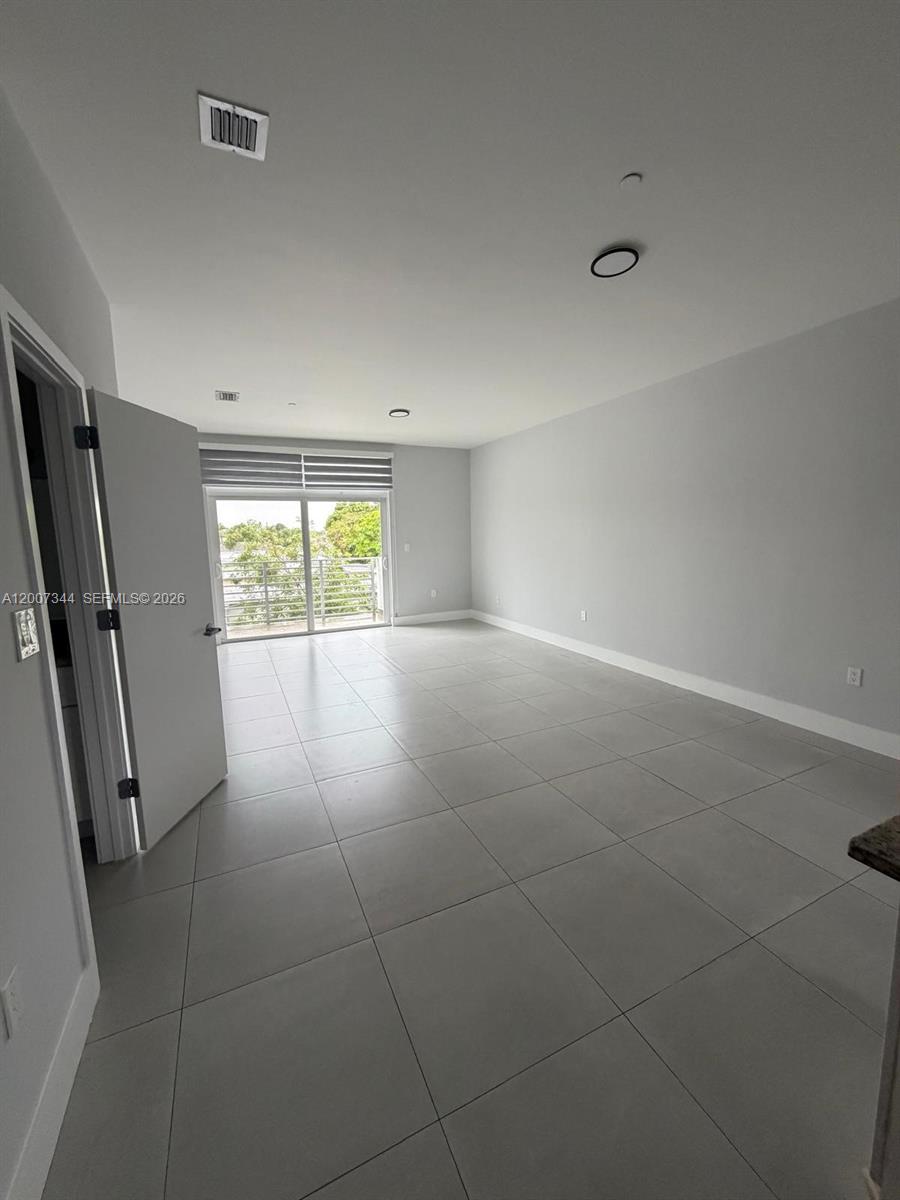 381 East 50th Street, Unit 6 Hialeah, FL 33013 - Photo 2 of 37 a view of an empty room with a window