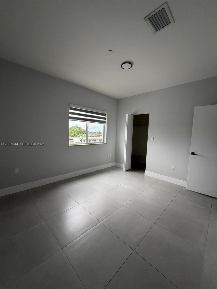 381 East 50th Street, Unit 6 Hialeah, FL 33013 - Photo 23 of 37 a view of an empty room with a window