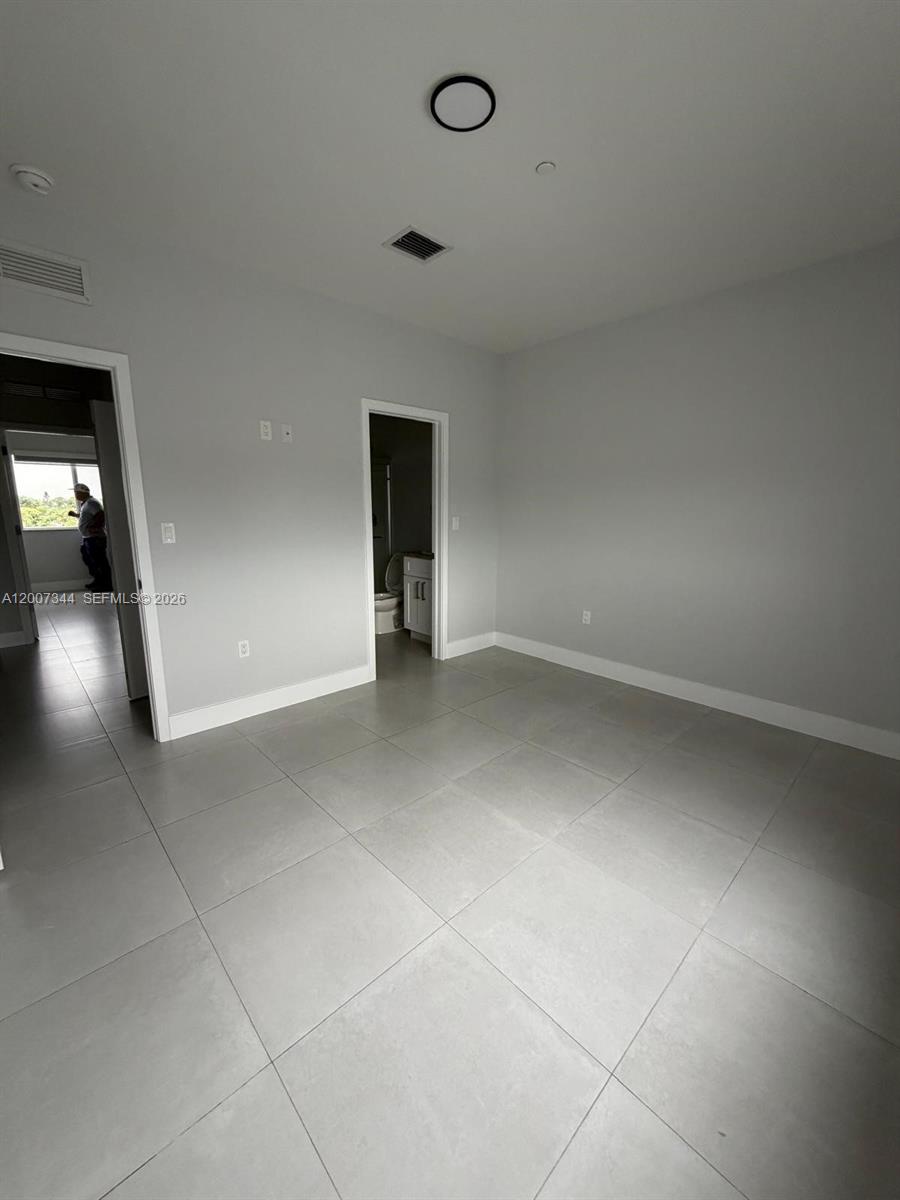 381 East 50th Street, Unit 6 Hialeah, FL 33013 - Photo 24 of 37 a view of an empty room with a window