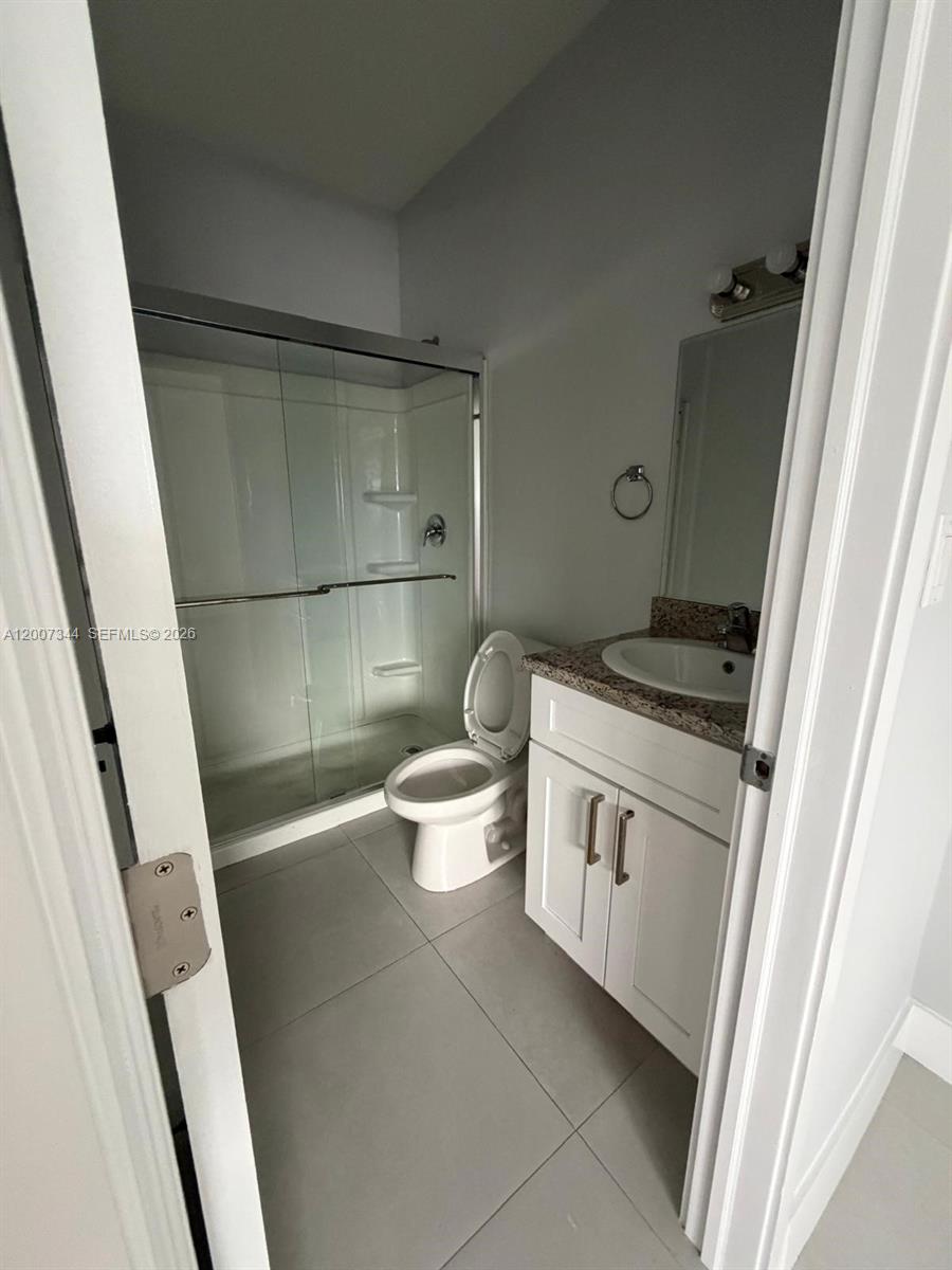 381 East 50th Street, Unit 6 Hialeah, FL 33013 - Photo 26 of 37 a bathroom with a granite countertop sink toilet and shower