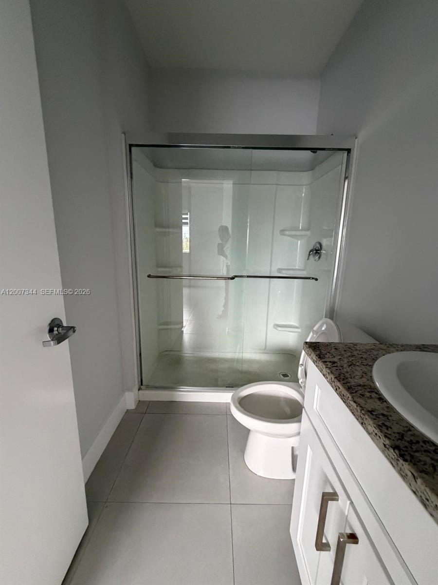381 East 50th Street, Unit 6 Hialeah, FL 33013 - Photo 27 of 37 a bathroom with a granite countertop sink a toilet and shower