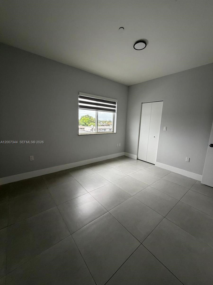 381 East 50th Street, Unit 6 Hialeah, FL 33013 - Photo 29 of 37 an empty room with a empty space and windows