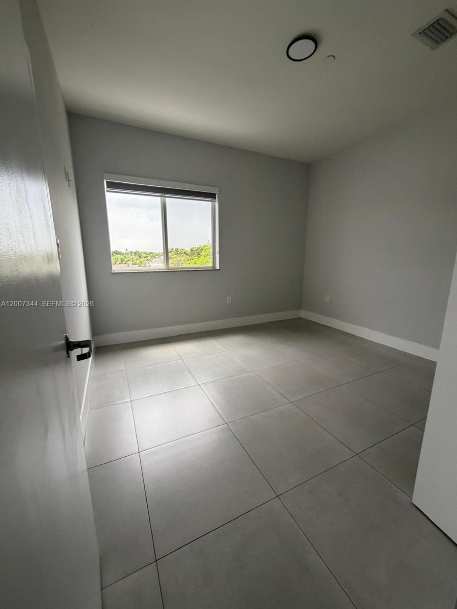 381 East 50th Street, Unit 6 Hialeah, FL 33013 - Photo 30 of 37 an empty room with windows and entrance