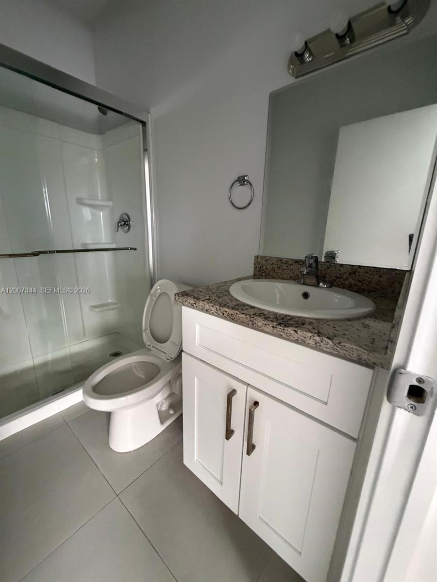 381 East 50th Street, Unit 6 Hialeah, FL 33013 - Photo 36 of 37 a bathroom with a granite countertop sink and a mirror