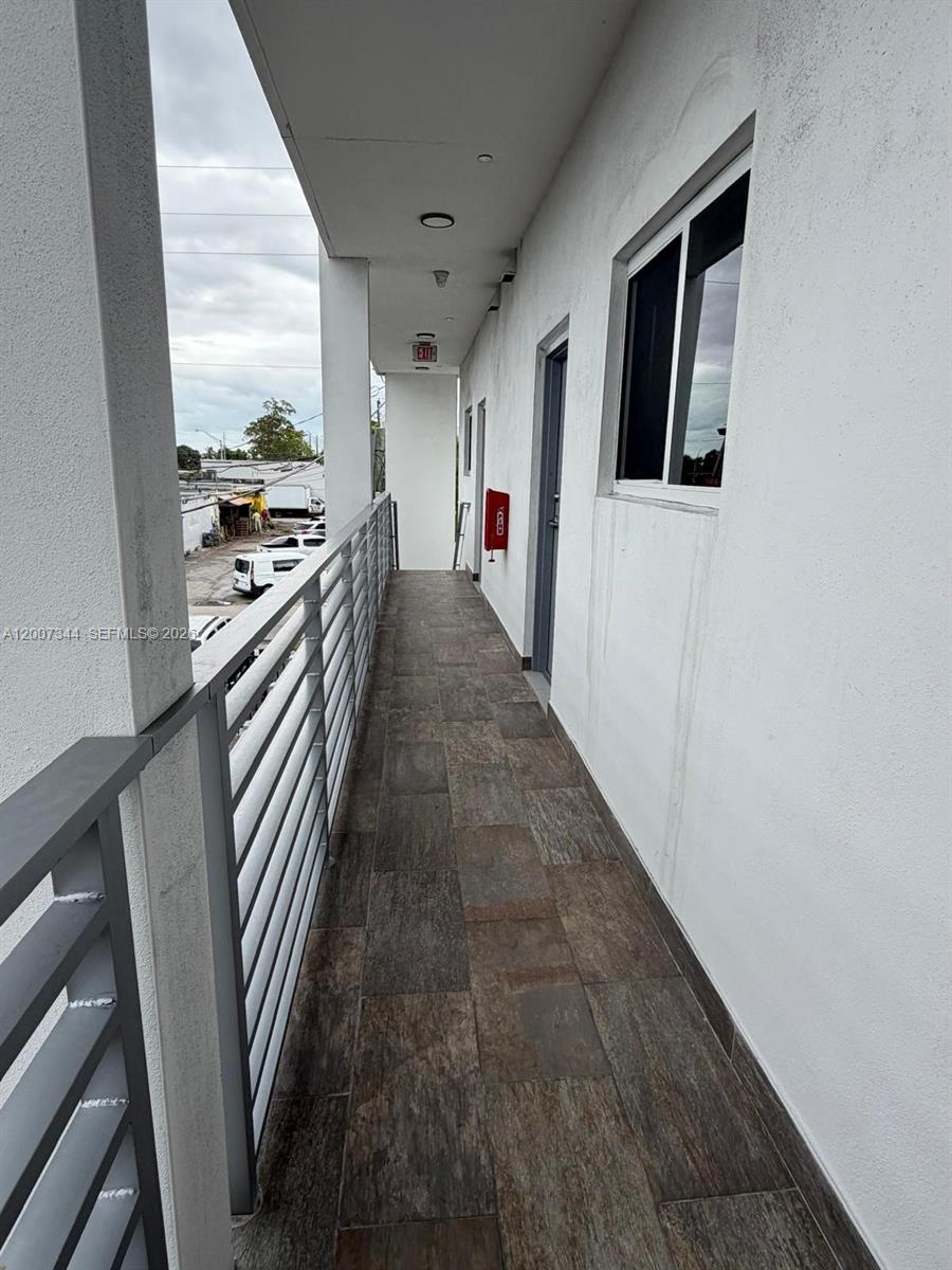 381 East 50th Street, Unit 6 Hialeah, FL 33013 - Photo 37 of 37 a hallway with white cabinets and white appliances