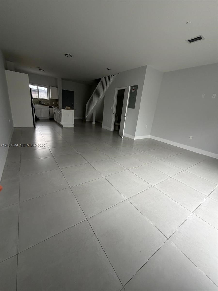 381 East 50th Street, Unit 6 Hialeah, FL 33013 - Photo 9 of 37 a view of empty room with stairs and a window