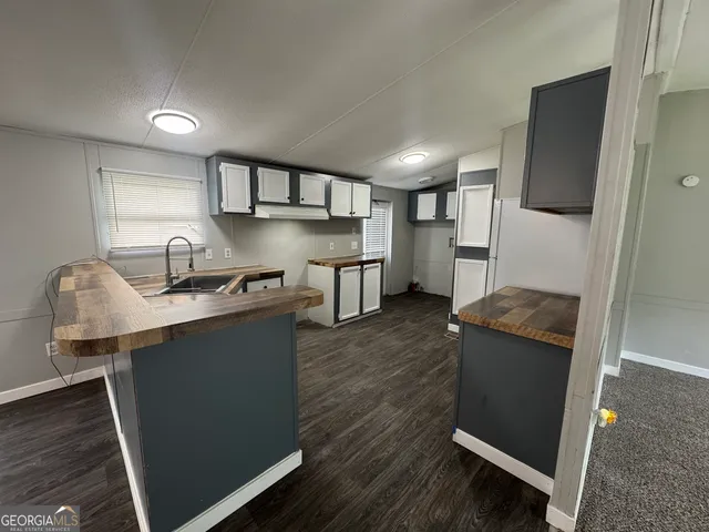 a kitchen with a sink stove and cabinets