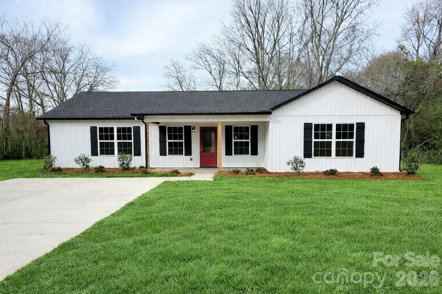a front view of house with yard and green space