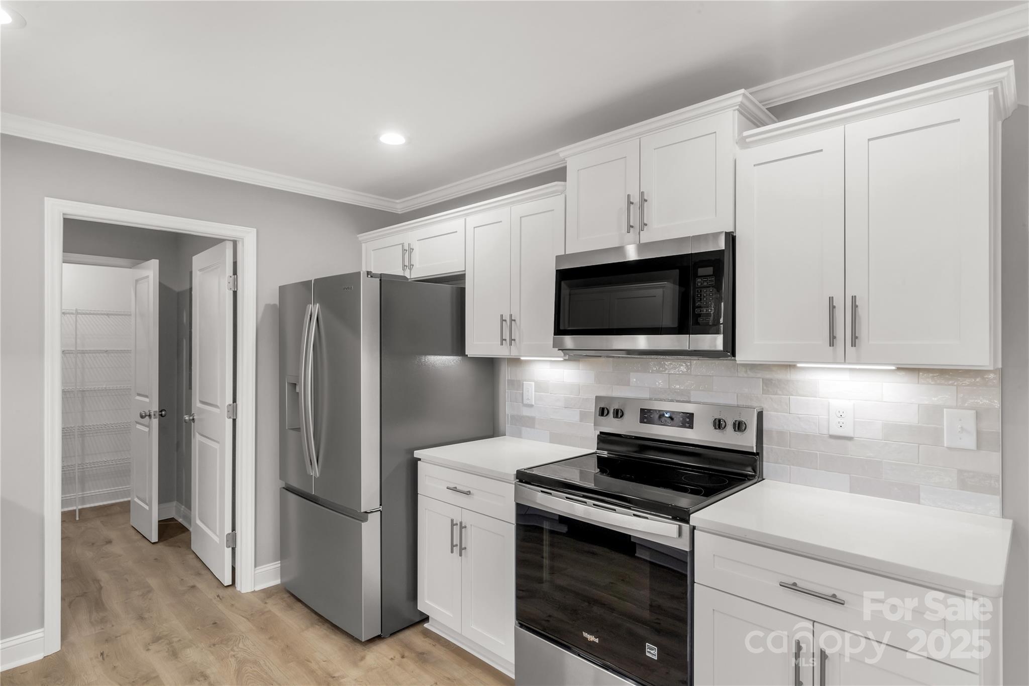 2166 Reeves Road Lancaster, SC 29720 - Photo 14 of 32 a kitchen with stainless steel appliances a refrigerator stove and microwave