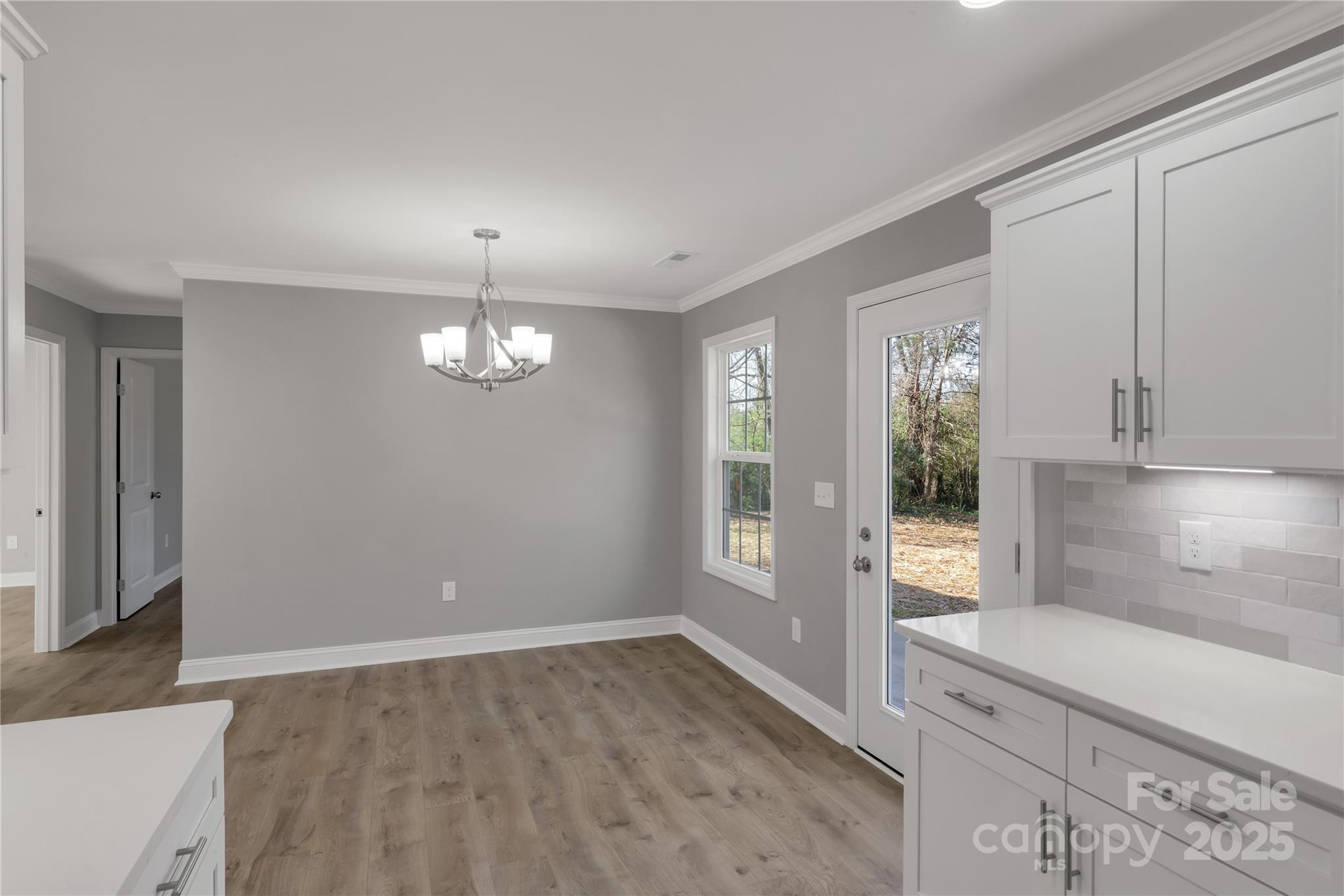 2166 Reeves Road Lancaster, SC 29720 - Photo 15 of 32 wooden floor in an empty room with a window