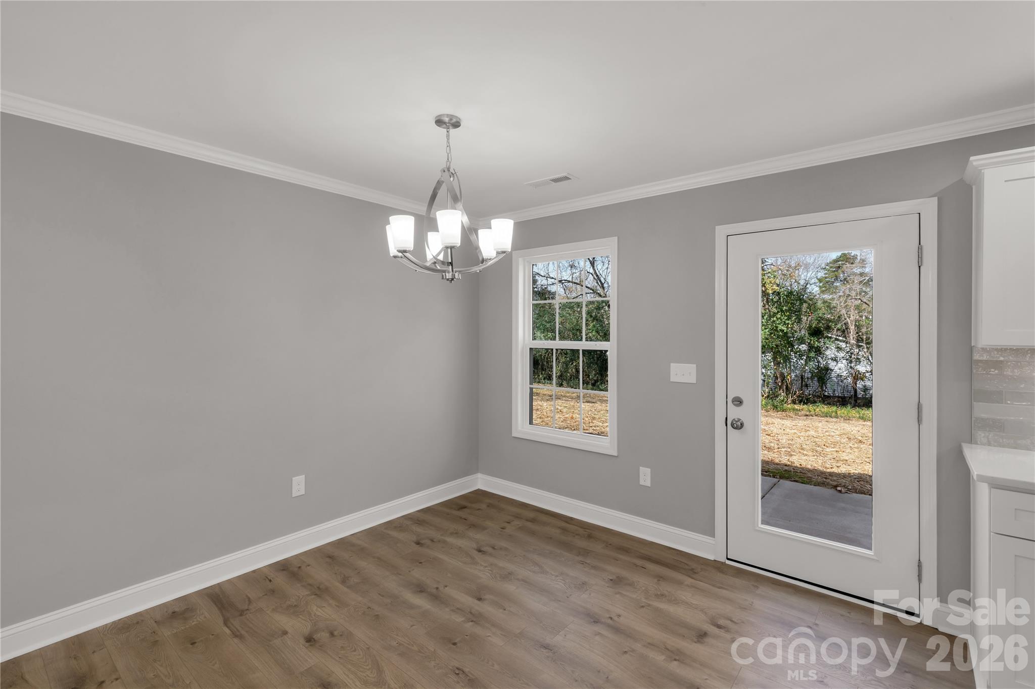 2166 Reeves Road Lancaster, SC 29720 - Photo 15 of 37 a view of an empty room with wooden floor and a window